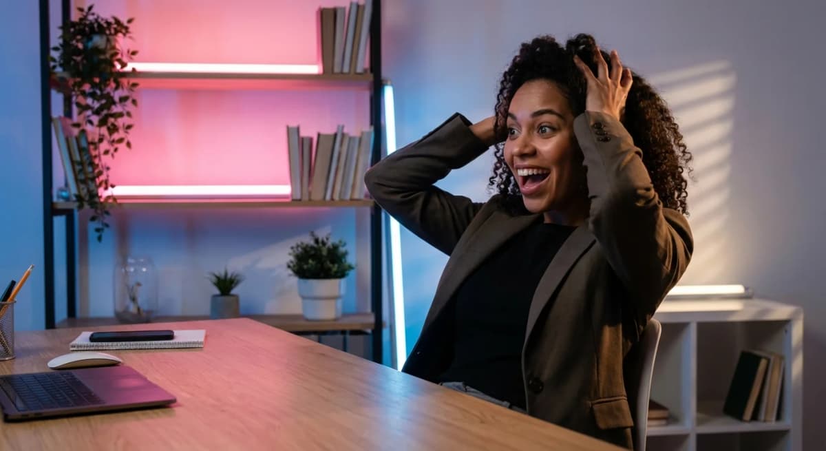 Professional discovering RSS feed URL at desk with pink and blue lighting